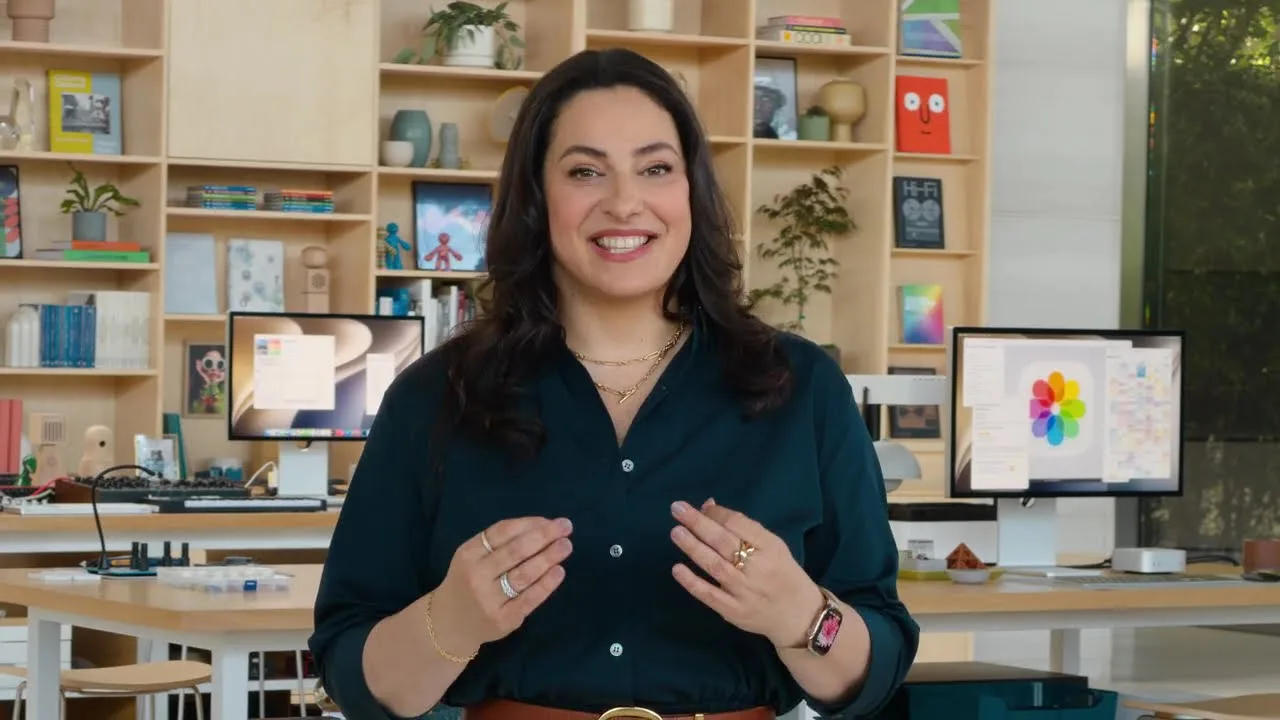 A presenter in Apple’s WWDC 2026 keynote, with two displays visible behind her